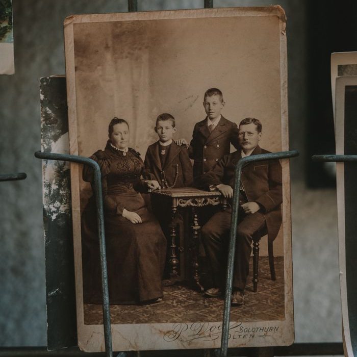 Home Sepia-toned photograph of a family in a vintage frame, showcasing historic memories.